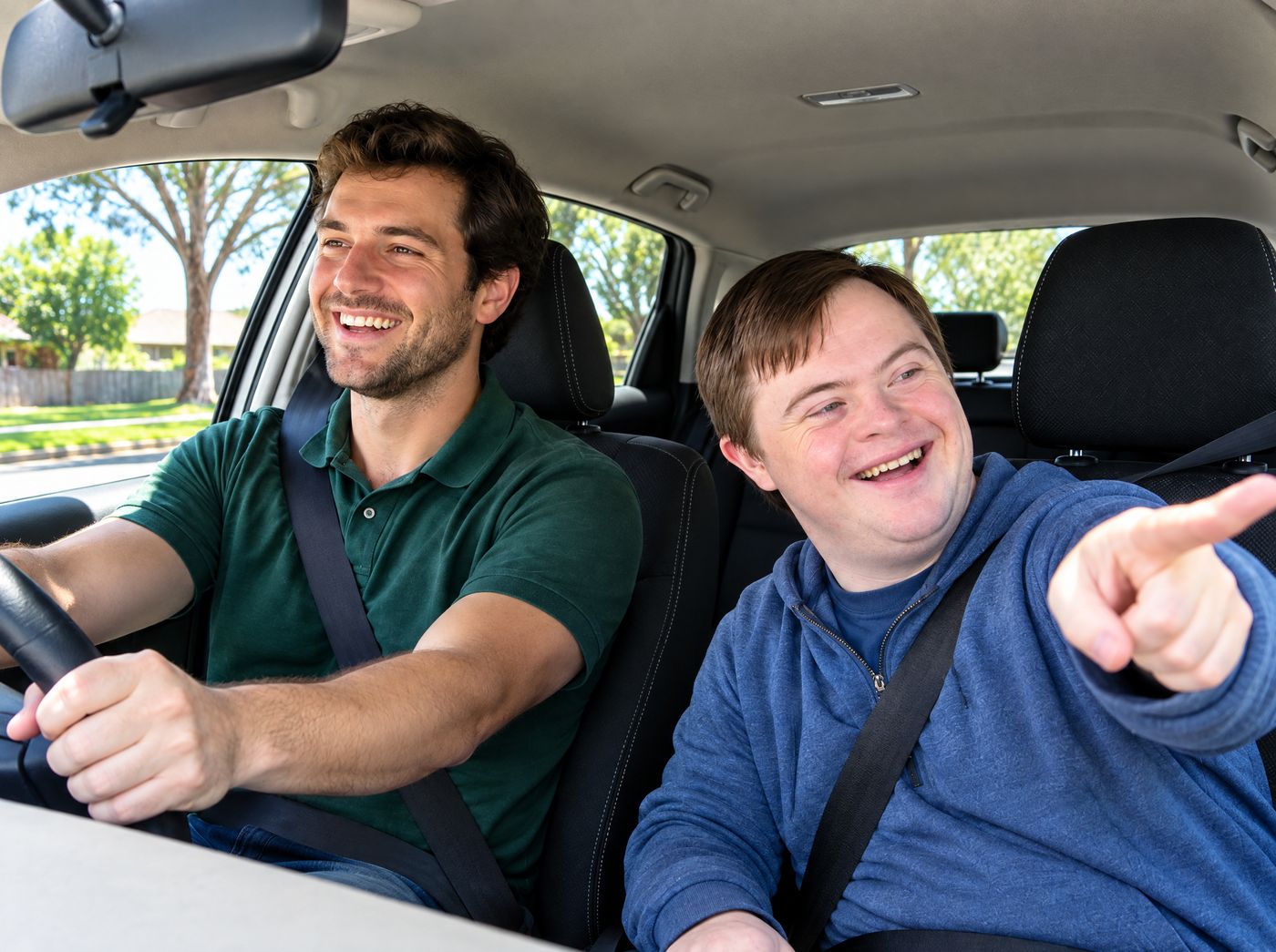 A young man points out the way as his support worker drives